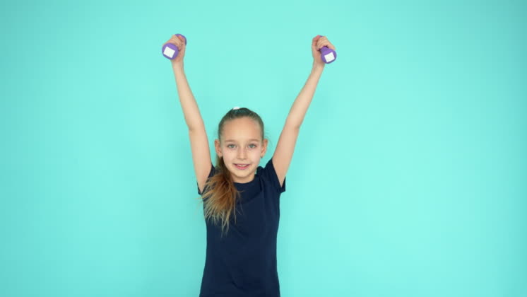 Video: Young teenager girl lifting dumbbell at gym training on ...