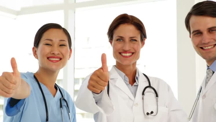 Medical team giving thumbs up to camera Medical team giving thumbs up ...